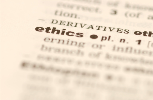 A dictionary with the camera focused on the definition of the word “ethics”