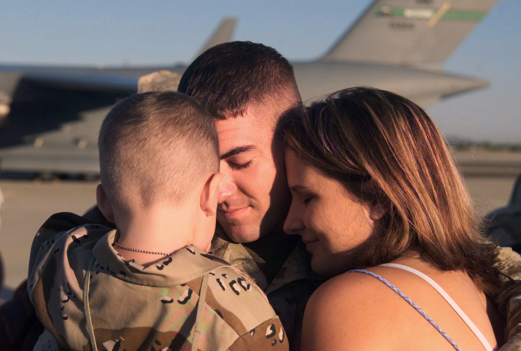 Family hugging service member after returning home