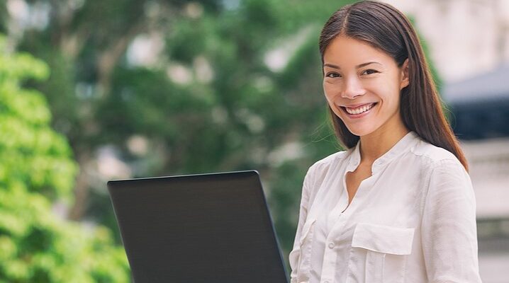 woman working on computer in park