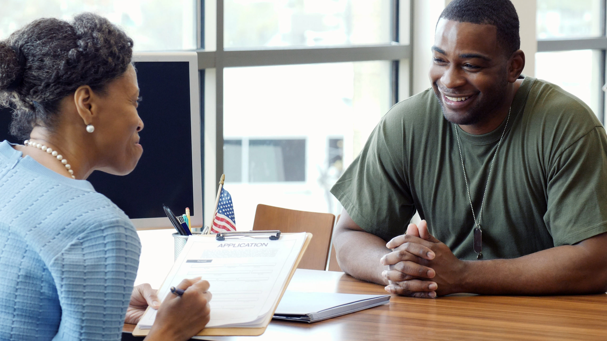 soldier discusses an application with an interviewer
