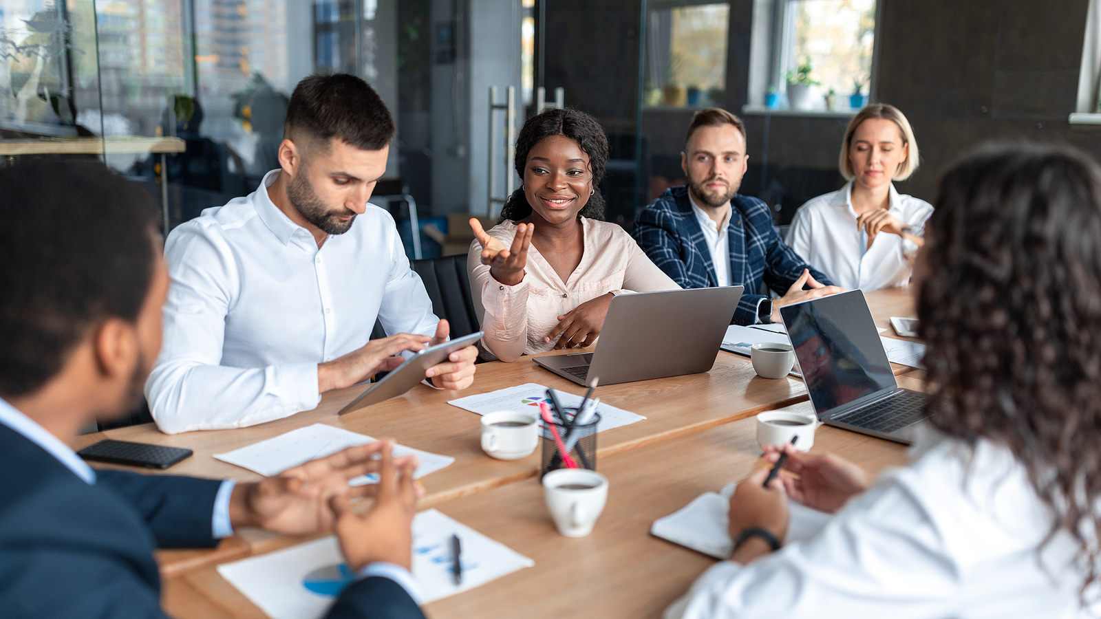 People Having a meeting and talking around a table.